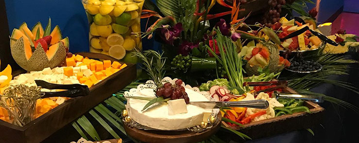 A Mel's Diner catering spread including fruits, vegetables and fine cheeses.