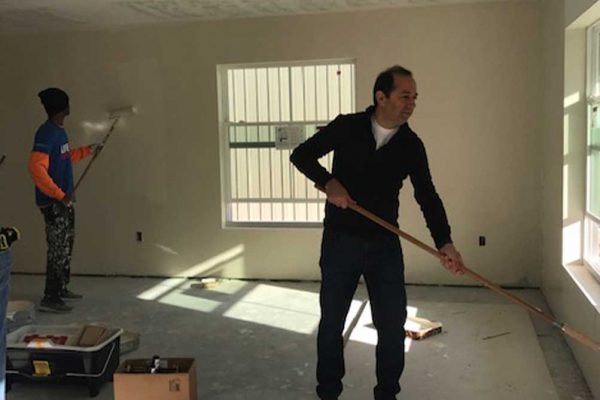 Painting interior of newly built house with Habitat for Humanity | Mel's Diners Community Involvement